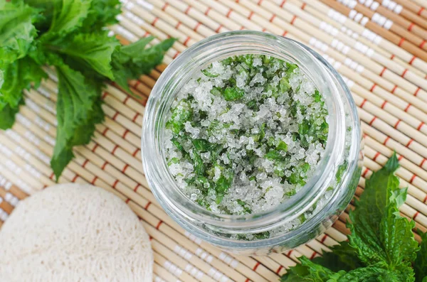 Homemade mint exfoliating scrub (foot soak, bath salt) with sugar, chopped mint leaves, olive oil end essential mint oil. Natural skin and hair care. DIY beauty treatments, spa recipe. Copy space.