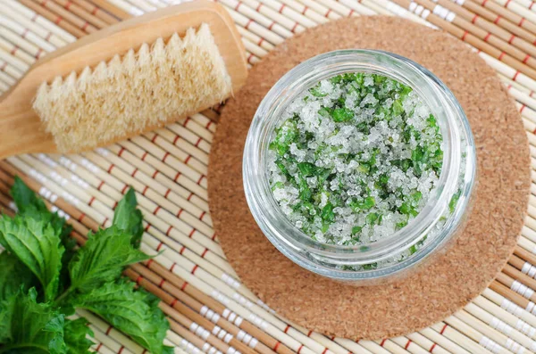 Homemade mint exfoliating scrub (foot soak, bath salt) with sugar, chopped mint leaves, olive oil end essential mint oil. Natural skin and hair care. DIY beauty treatments, spa recipe. Copy space.