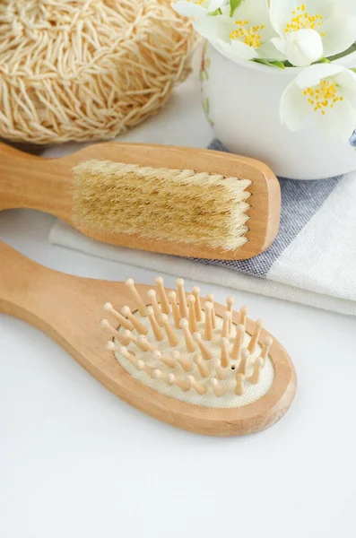 Wooden hair brush and massage body brush. Eco friendly toiletries. Hygiene, natural beauty treatment, zero waste concept. Copy space.