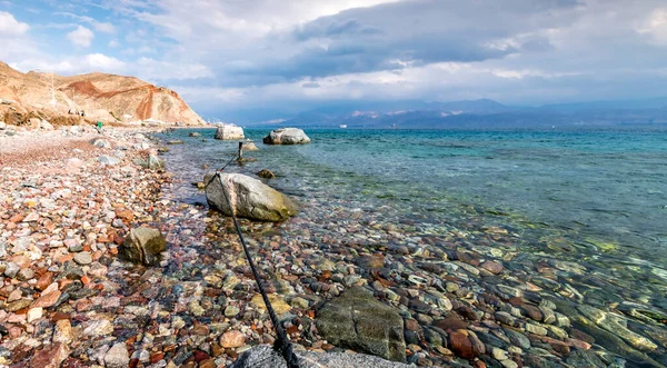 rocky Coastal landscape, beach and sea water, cloudy sky