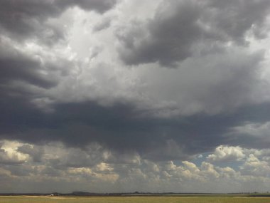 A thunderstorm builds up over the farmlands near Newcastle KZN, South Africa. clipart