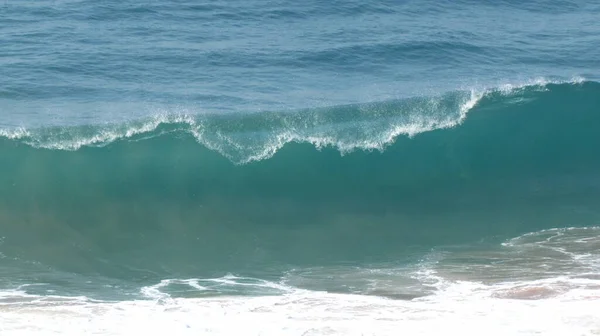 A beautiful clean ocean wave as it\'s breaking.