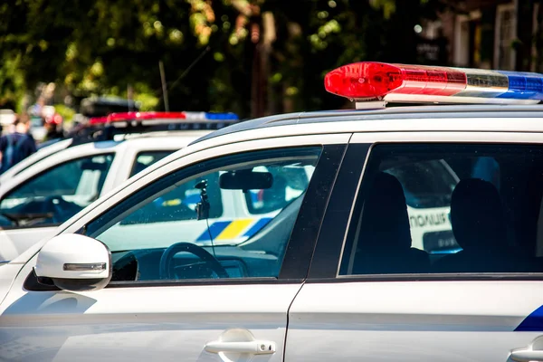 Polis arabaları karşı bir şehir sokak bir parçası üzerinde sinyal lambaları. (Güvenlik, yardım, hukuk - kavram)