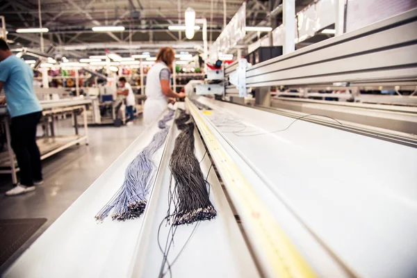 Industrial landscape with wire on a machine at a modern plant for the production of wiring for automobiles.