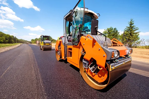 industrial landscape with rollers that rolls a new asphalt in th