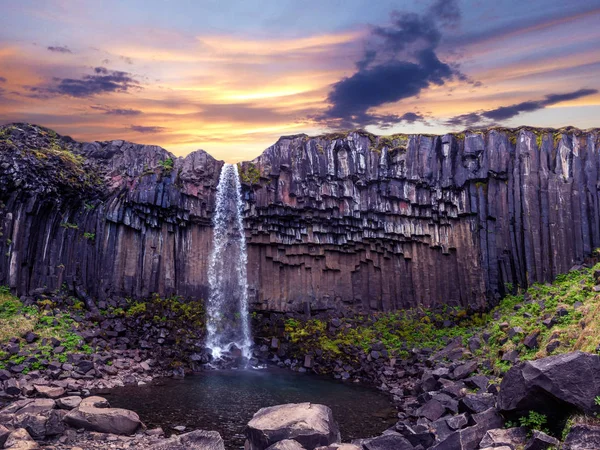 Magical landscape with a famous Svartifoss waterfall in the midd