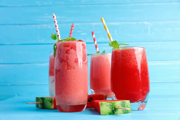 Watermelon smoothie drinks of summer on blue wood background with copy space. A cold refreshing drink for health.