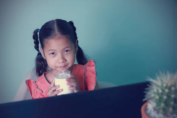 Kids Learning Education Online Using Computer Asian Girl Drinking Milk Stock Picture