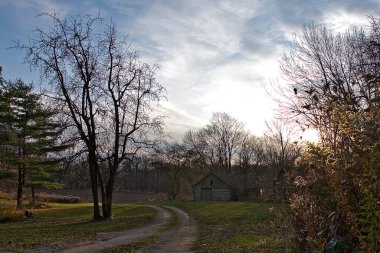 Rustic Wood Cabin made from logs in the countryside with clouds in the background