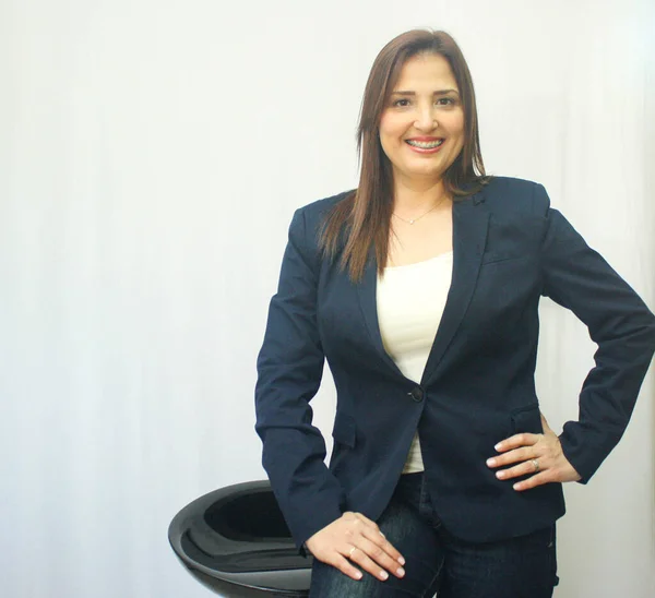 executive woman looking at camera smiling on white background with suit