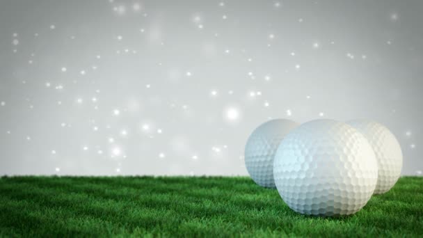 Golf balls on grass field with white bokeh background - seamless loop — Stock Video