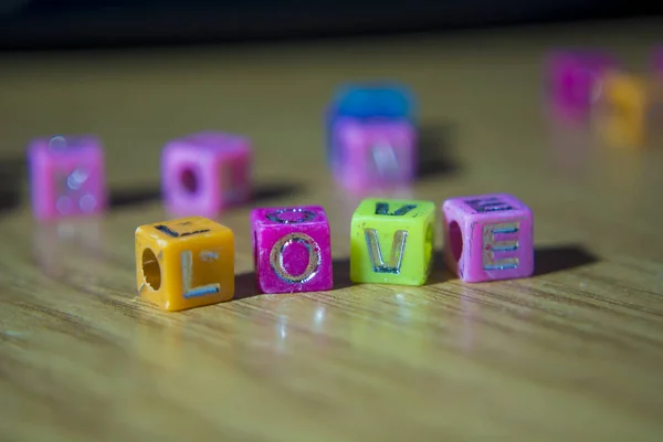 Love word on a wood table.Love concept,happiness, type letters