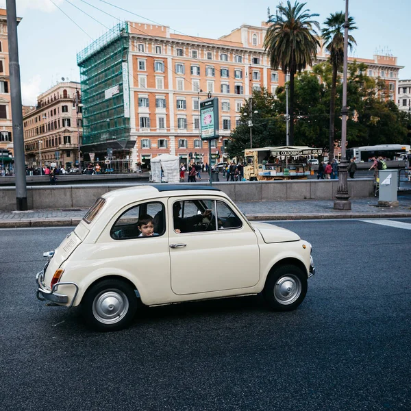 Milan, Italy. May, 2020. Sad little boy in the window of a passing retro car. — Stock Photo, Image