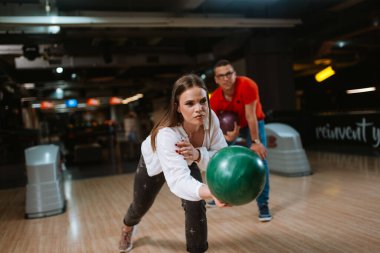 Bovling salonunda top atan güzel beyaz bir çift. Bowling kulübündeki erkek arkadaş ve kız arkadaş