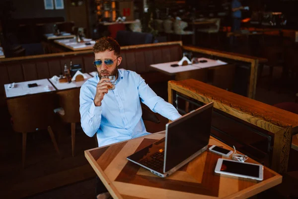caucasian businessman with laptop at bar