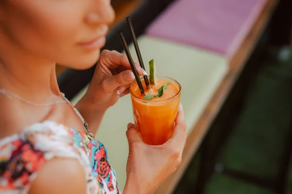 beautiful woman drinking cocktail in summer