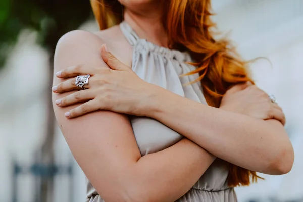 beautiful red hair woman with ring on her hand