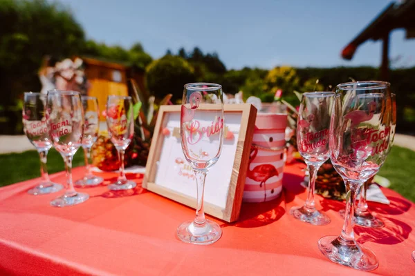 Decorated table with pineapple cocktails to celebrate a bachelorette party in a beautiful garden. The girls are having a party