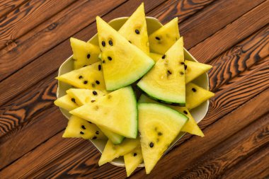 Tabakta taze sarı karpuz dilimleri.