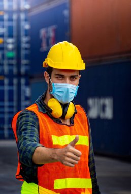 Nakliye endüstrisindeki erkek işçilerin fabrikada Covid 19 virüsünün yayılmasını önlemek için hijyenik maskeleri var..