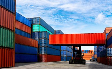 Nakliye endüstrisinde konteynır kutusu taşıyan bir forklift ve depo deposunda kargo işi..