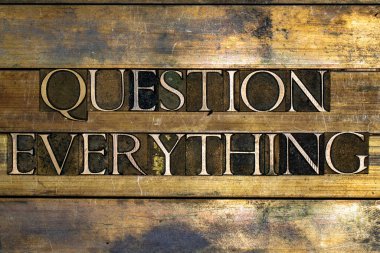 Photo of real authentic typeset letters forming Question Everything text on vintage textured silver grunge copper and gold background clipart