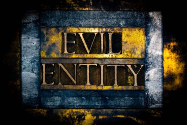 Evil Entity text formed with real authentic typeset letters on vintage textured silver grunge copper and gold background clipart