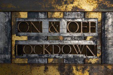 On and Off Lockdown text message authentic on textured grunge copper and vintage gold background clipart