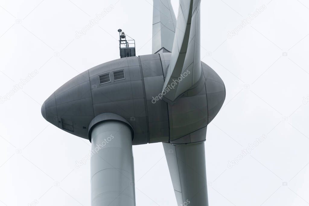 close up of the motor of a spinning windmill with a white background