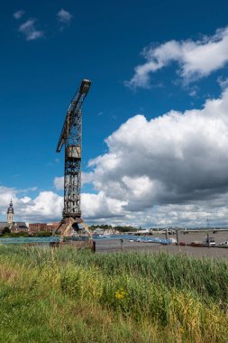 Temse Belgium, Tower crane, maintained as a last reminder of the Boelwerf with a blue sky and threatening clouds