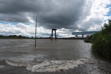 Temse, Belgium, July 05, 2020, The Scheldt at high tide and storm clouds in Temse