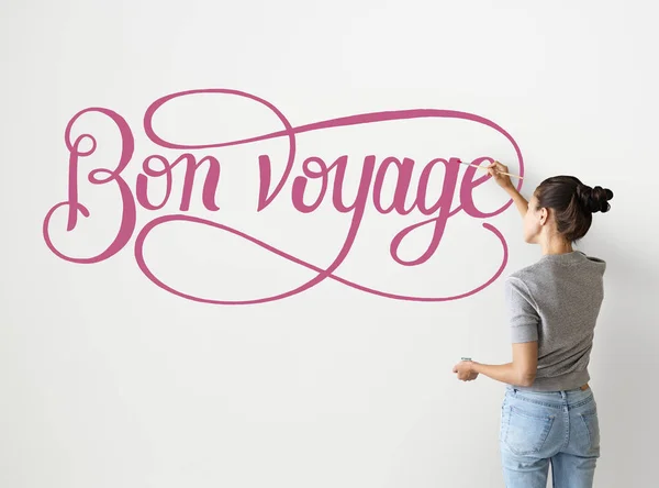 Artysta Kobieta Pisania Bon Voyage Ścianie — Zdjęcie stockowe