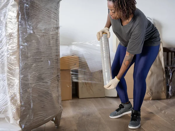African Woman Moving Furniture — Stock Photo, Image