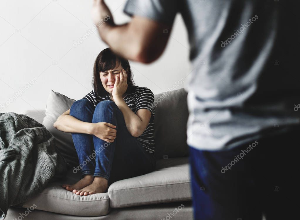 Unhappy couple arguing on the sofa