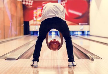 Boy bowling with two hands clipart