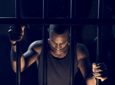 african man arrest, man in jail cage  clipart