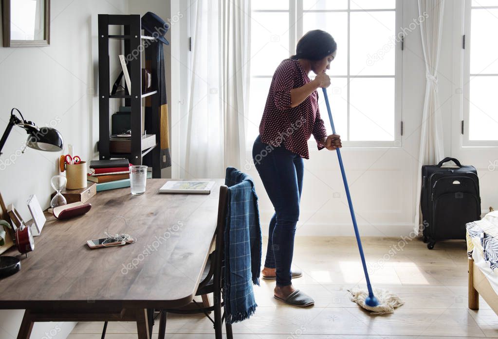 african woman cleaning room