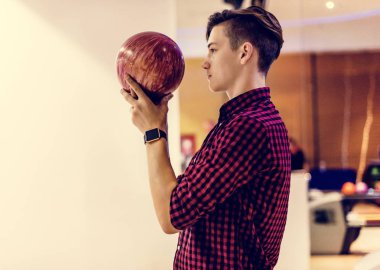 Boy about to roll a bowling ball hobby and leisure concept clipart