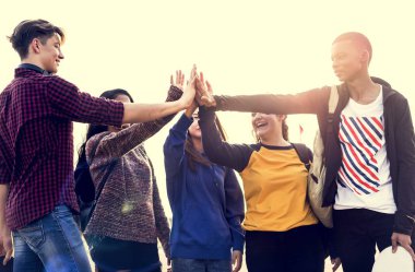 Group of friends all high five together support and teamwork concept clipart