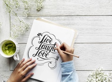 An artist creating hand lettering artwork from motivation quote clipart