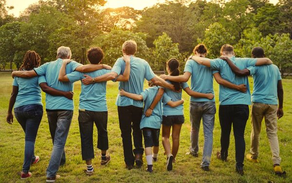 Volunteers holding around each other