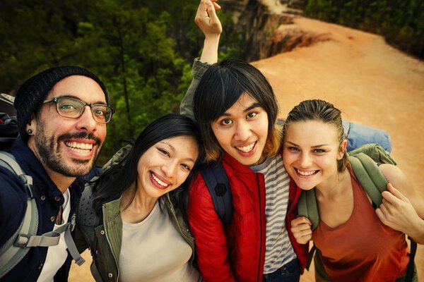 best Friends traveling together in forest and taking selfie photo 