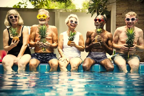 Group Diverse Senior Adults Sitting Poolside Holding Pineapples — Stock Photo, Image