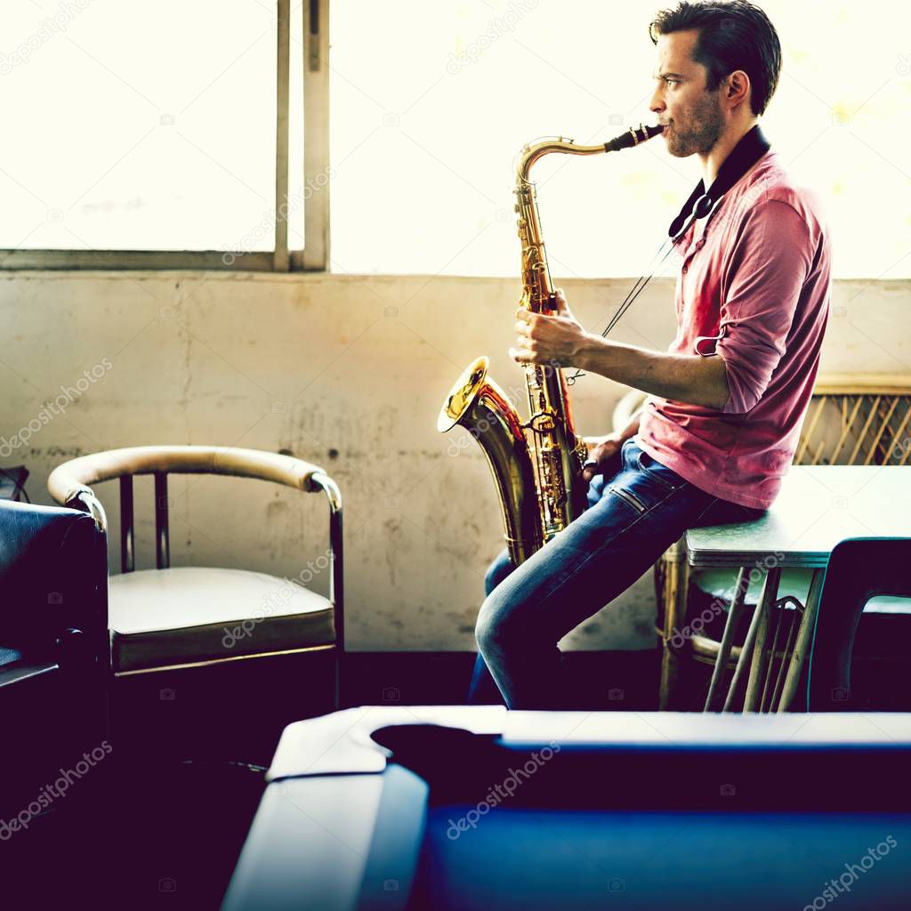 A musician guy playing saxophone alone