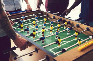 People playing a game of foosball clipart