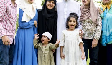 Muslim family having a good time outdoors clipart