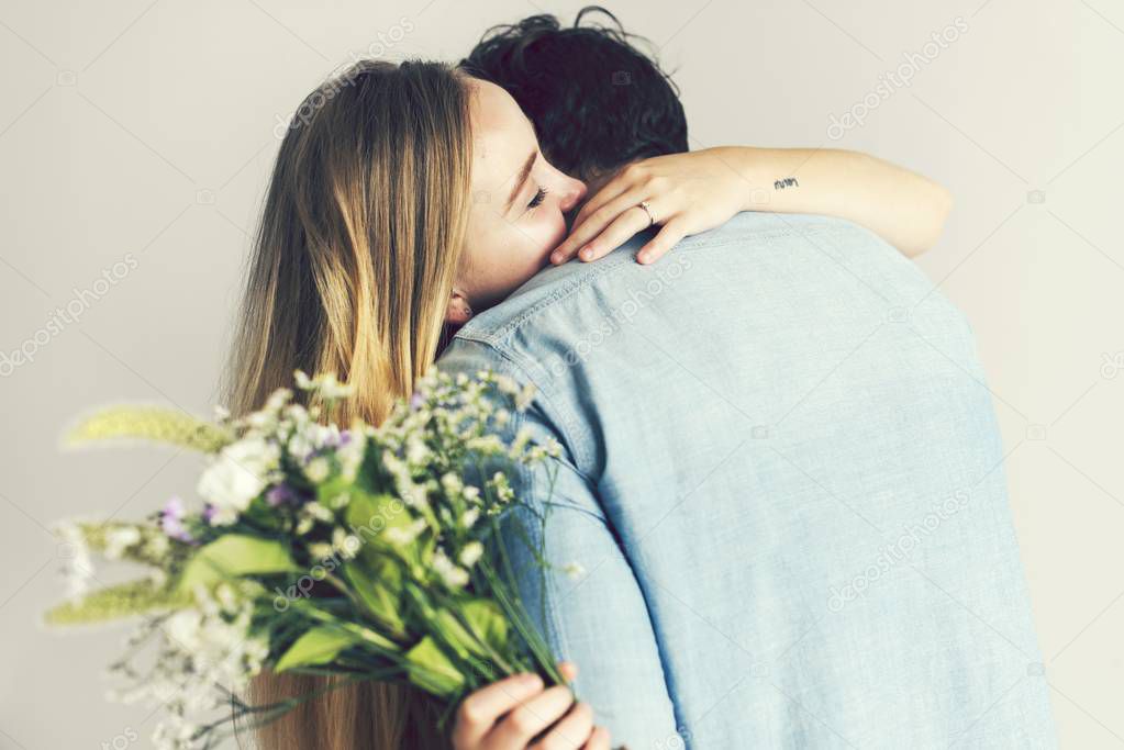 Girlfriend receiving a bouquet of flowers from her boyfriend