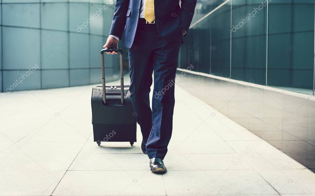 Businessman walking with a suitcase