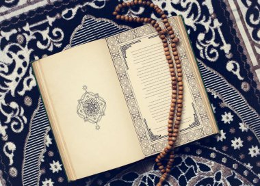 The Quran, the central religious text of Islam  clipart