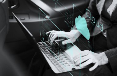 Bir arabada bir dizüstü bilgisayar üzerinde çalışan iş kadını